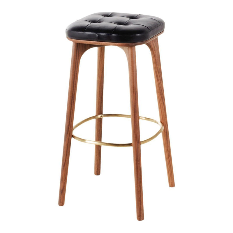 Black tufted cushion with walnut wood legs and a brass footrest, featuring a modern, minimalist design.