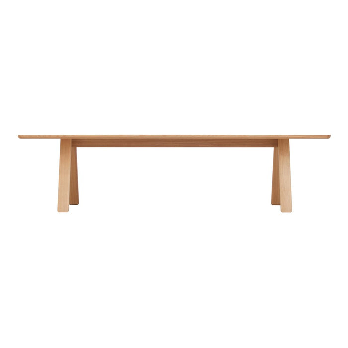 Light natural wood dining table with a simple, minimalist design and smooth surface. Perfect for modern decor.