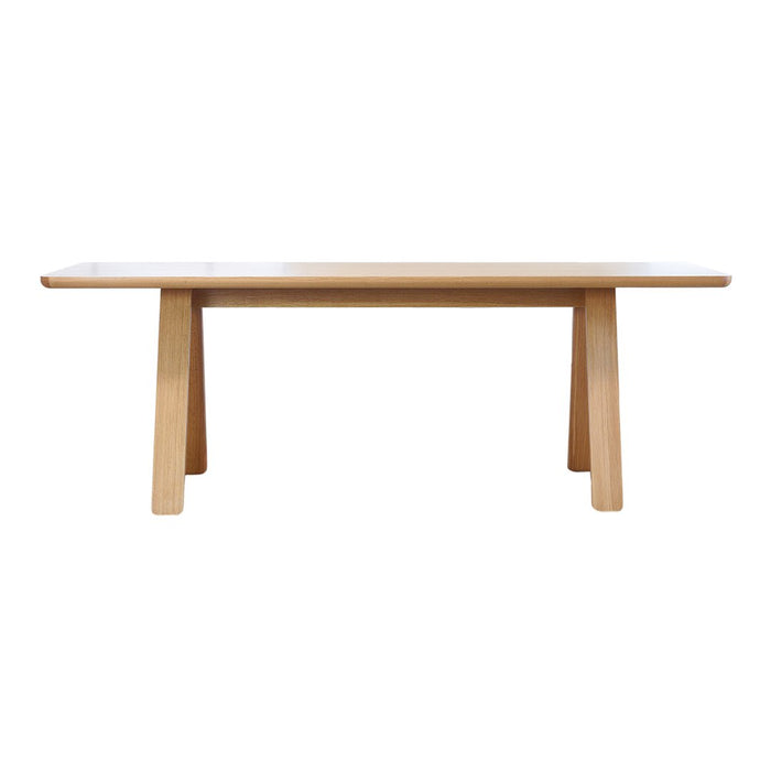 Natural wood dining table with a light oak finish and a sleek, minimalist design. Perfect for modern interiors.