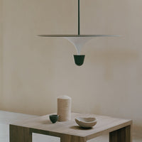 Modern pendant lamp in white and green, showcasing minimalist design against a soft beige backdrop.