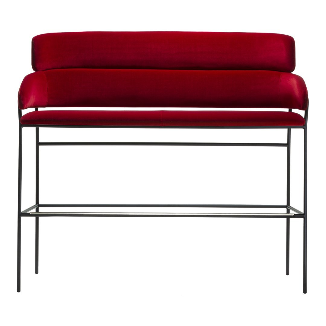 Red velvet upholstery on a sleek black metal frame, featuring a modern minimalist design.
