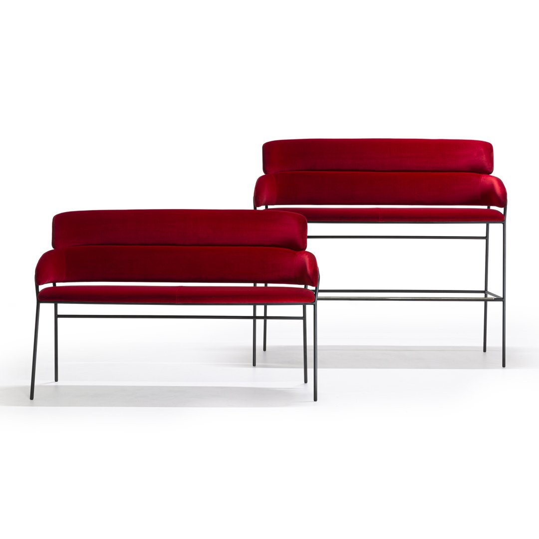 Pair of modern sofas featuring rich red velvet upholstery with sleek black metal frames. Elegant and stylish design.