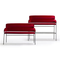 Pair of modern sofas featuring rich red velvet upholstery with sleek black metal frames. Elegant and stylish design.