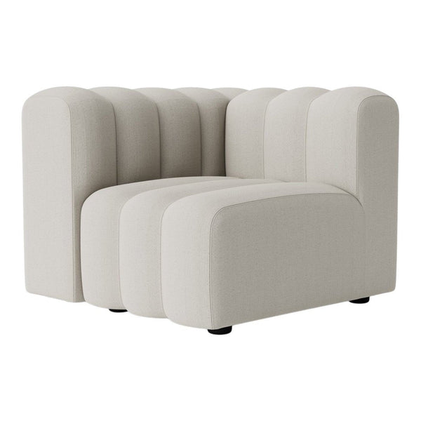 Cream-colored tufted couch with rounded edges and a modern design. Perfect for contemporary decor styles.