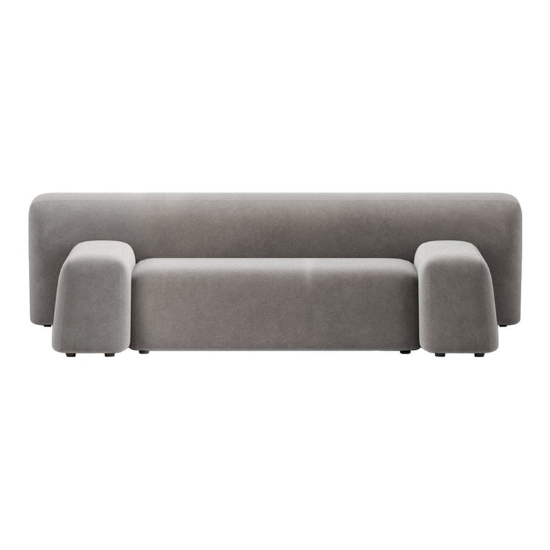 Stylish gray velvet sofa with a minimalistic design and smooth, curved edges for modern decor.