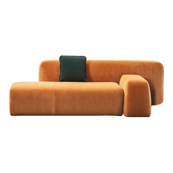 Stylish orange sofa with smooth, curved lines and a contrasting green accent pillow for modern decor.