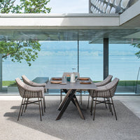 "Outdoor dining set with sleek gray table, woven beige chairs, and a modern geometric pattern, complemented by serene views."