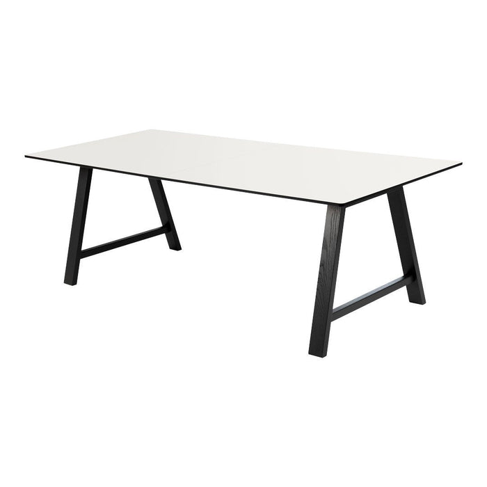 Modern rectangular table with a sleek white surface and contrasting black legs. Ideal for contemporary decor.