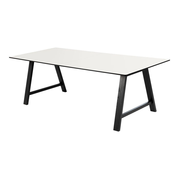 Modern white tabletop with sleek black legs, minimalist design perfect for contemporary spaces.