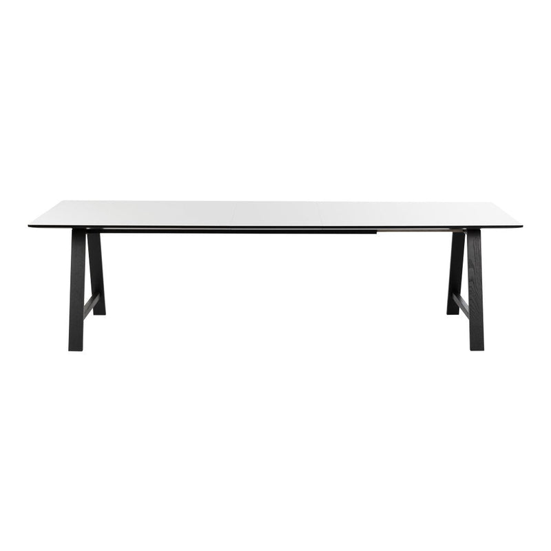 Modern white tabletop with sleek black legs, featuring a minimalist design and smooth finish. Perfect for contemporary decor.