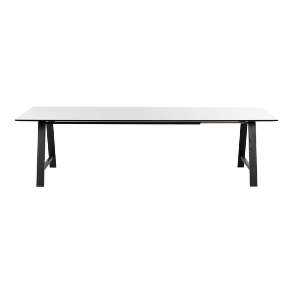 Sleek white top dining table with minimalist black legs, showcasing a modern and versatile design.