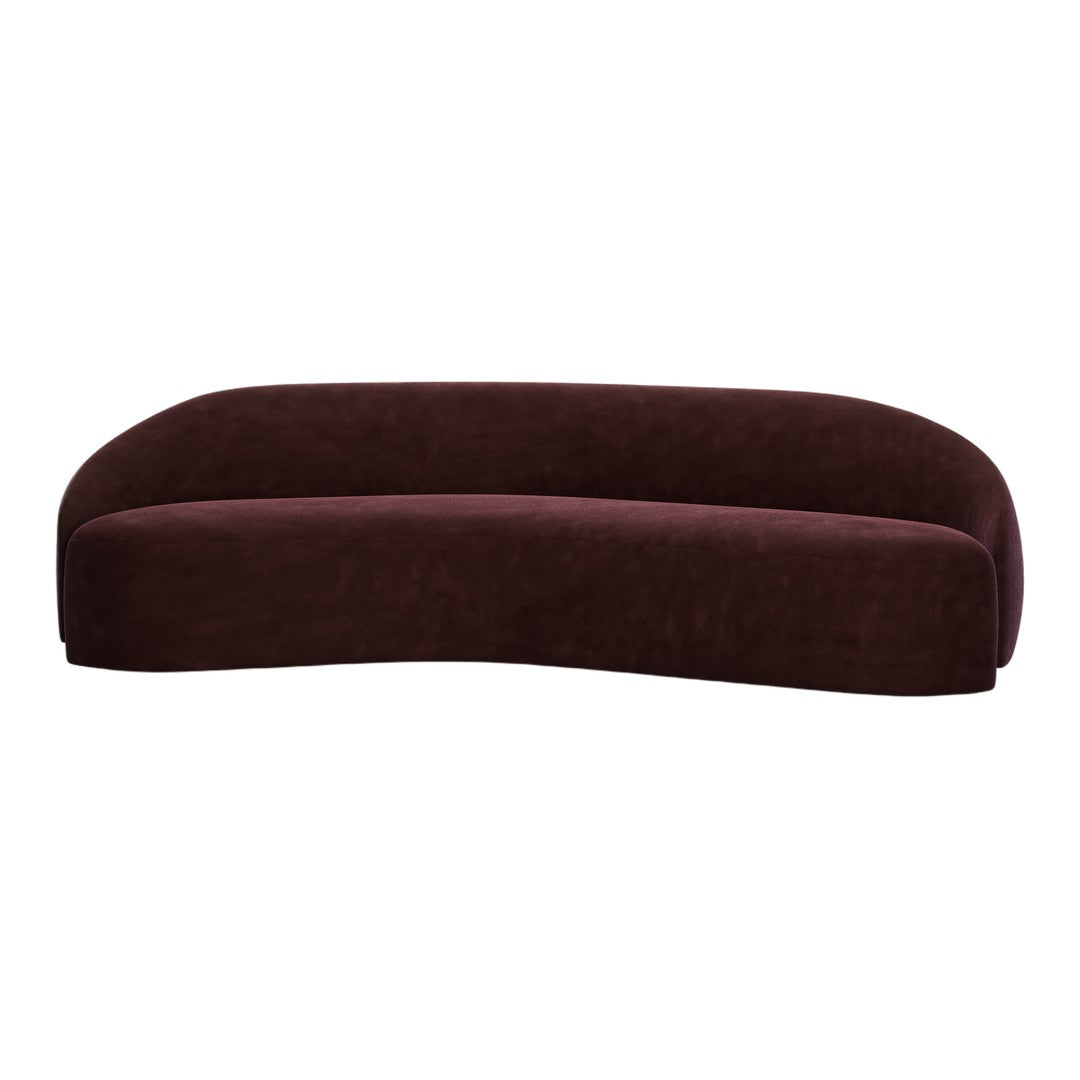 Curved sofa in rich burgundy velvet, showcasing a smooth, soft texture and modern, minimalist design.
