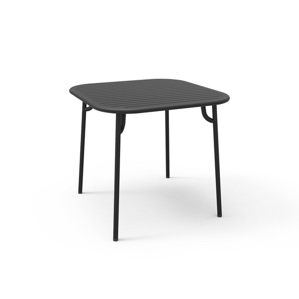 Square black table with a smooth top and sturdy black legs, ideal for modern decor. Simple and elegant design.