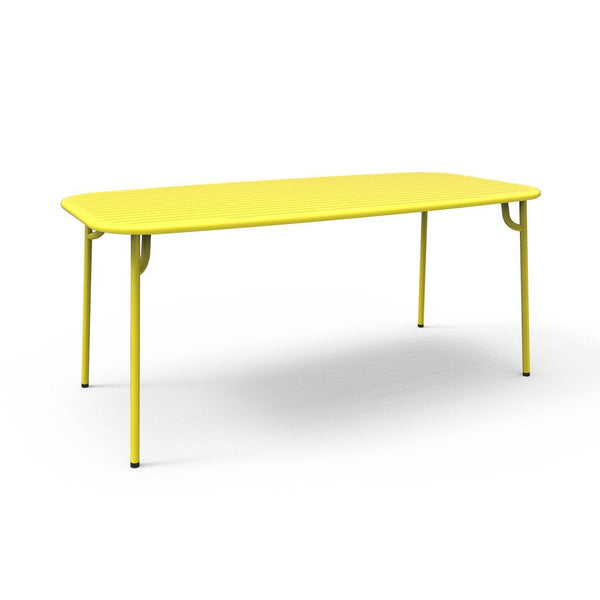 Bright yellow rectangular table with smooth surface and sleek metal legs, ideal for modern decor.