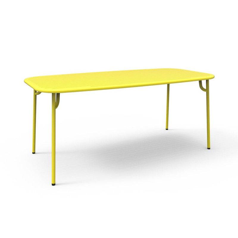 Bright yellow rectangular table with smooth surface and sleek metal legs, ideal for modern decor.