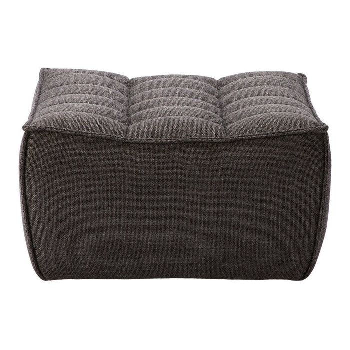 Gray tufted ottoman with a textured surface, featuring a subtle herringbone pattern for a modern touch.