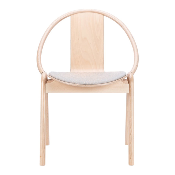 Minimalist wooden chair with a natural finish and a soft gray cushion, featuring a circular back design.