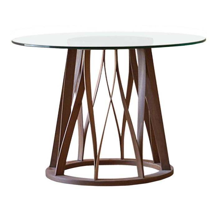 Modern round table with a clear glass top and a geometric brown wooden base pattern.