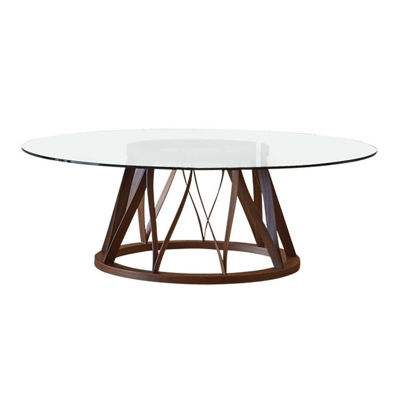 Modern round table with a clear glass top and a geometric brown wood base, showcasing a sleek and elegant design.