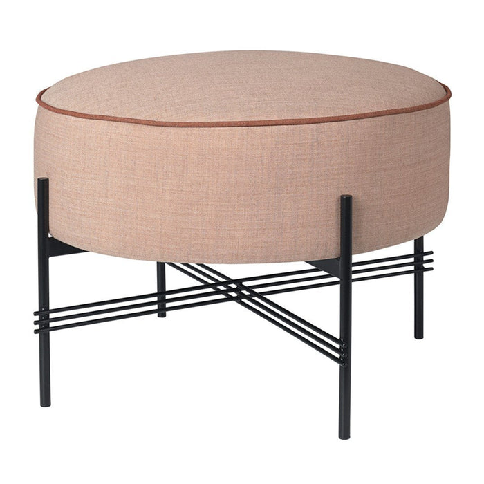 Round pink ottoman with a sleek black metal base and minimalist cross-pattern legs. Elegant and modern design.
