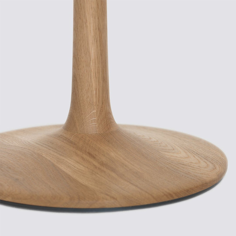 Natural wood grain table base with a smooth, circular design in light oak color. Elegant and modern aesthetic.