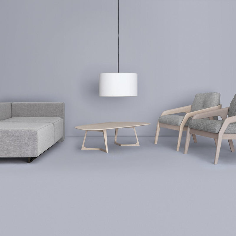 Modern gray sofa, light gray chairs, and a white pendant lamp against a soft gray backdrop. Clean lines and minimalist design.