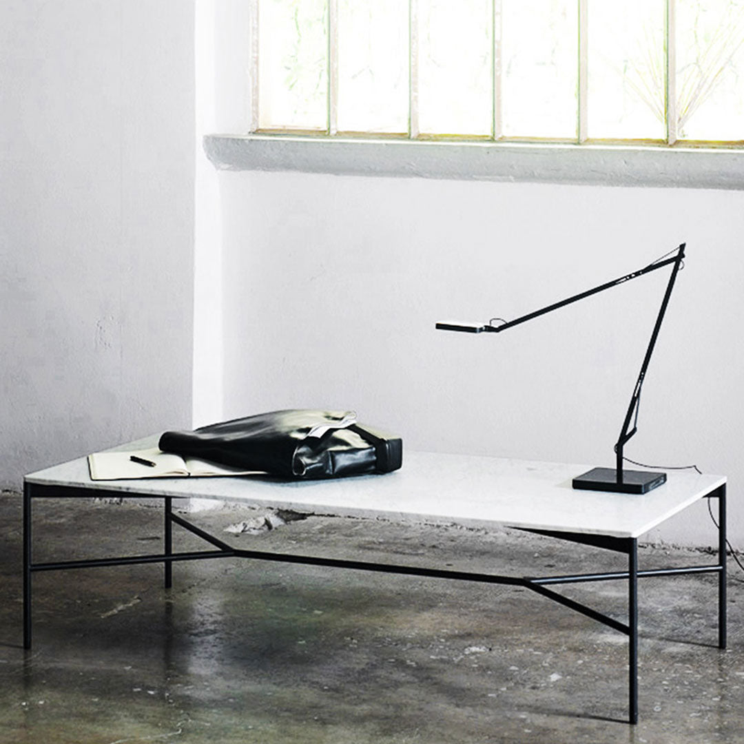 Modern white marble coffee table with sleek black metal frame, featuring a minimalist aesthetic and clean lines.