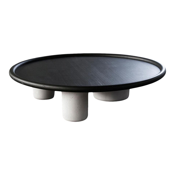Black round coffee table with a smooth surface, featuring three minimalist white legs. Stylish and modern design.