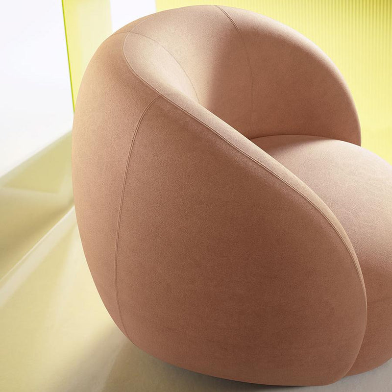 Soft pink curved chair against a bright yellow background, featuring smooth, modern textures.