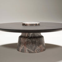 Round marble table featuring a dark gray top with subtle veining and a unique marbled base in earthy tones.