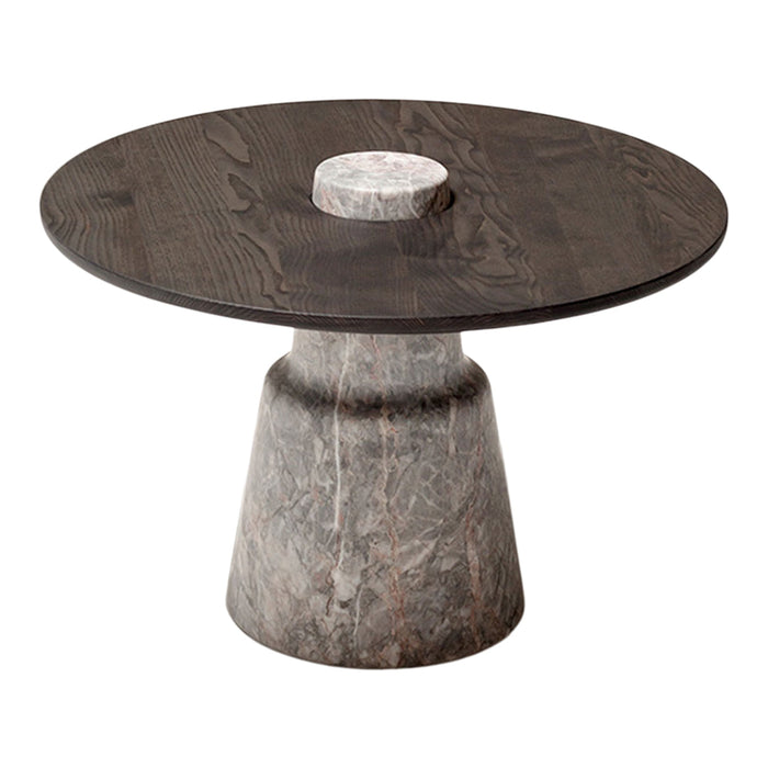 Round coffee table featuring a dark wood top and a textured gray stone base with a contrasting white center.