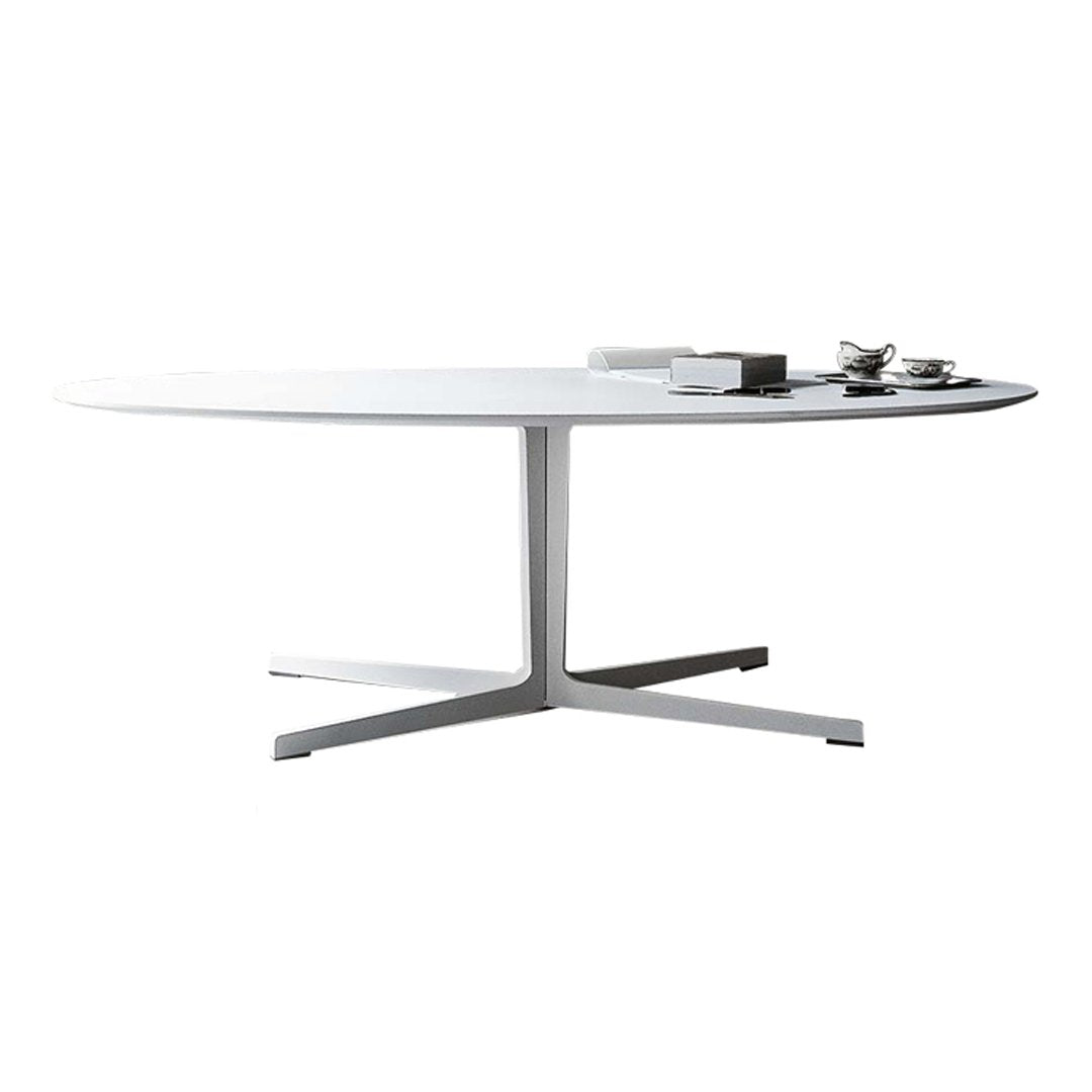 Modern oval white dining table with a sleek silver base, minimalist design, ideal for contemporary interiors.