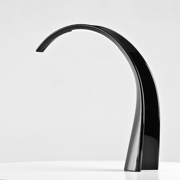 Sleek black modern lamp with a smooth, curved design and glossy finish on a minimalist background.
