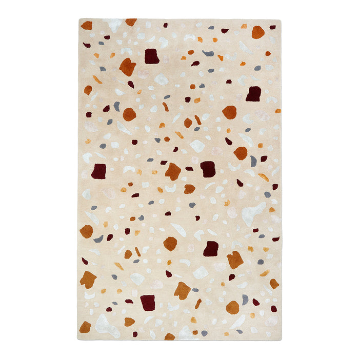 Beige area rug featuring earthy tones with scattered patterns in rust, cream, gray, and amber accents.