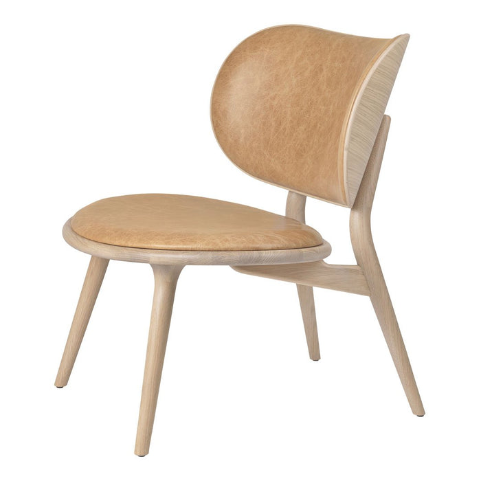 Light wood chair with a smooth tan seat and backrest, featuring a minimalist design and organic curves.