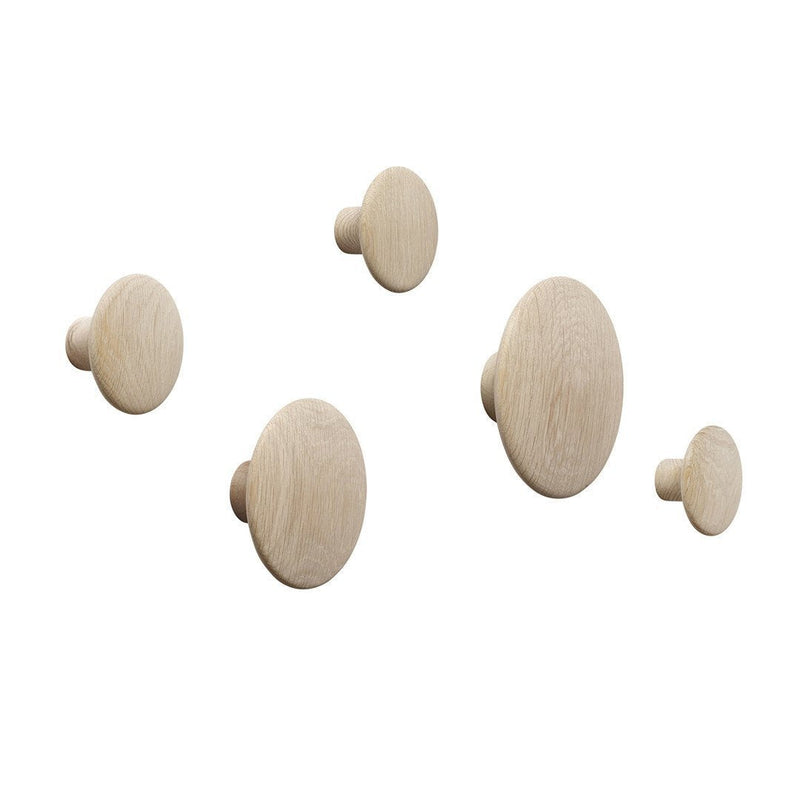 Set of five natural wooden wall hooks in light beige tones with smooth, rounded patterns.