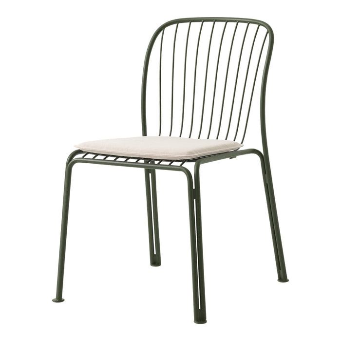 Green metal chair with sleek wire design and light beige cushion for a modern, minimalistic look.