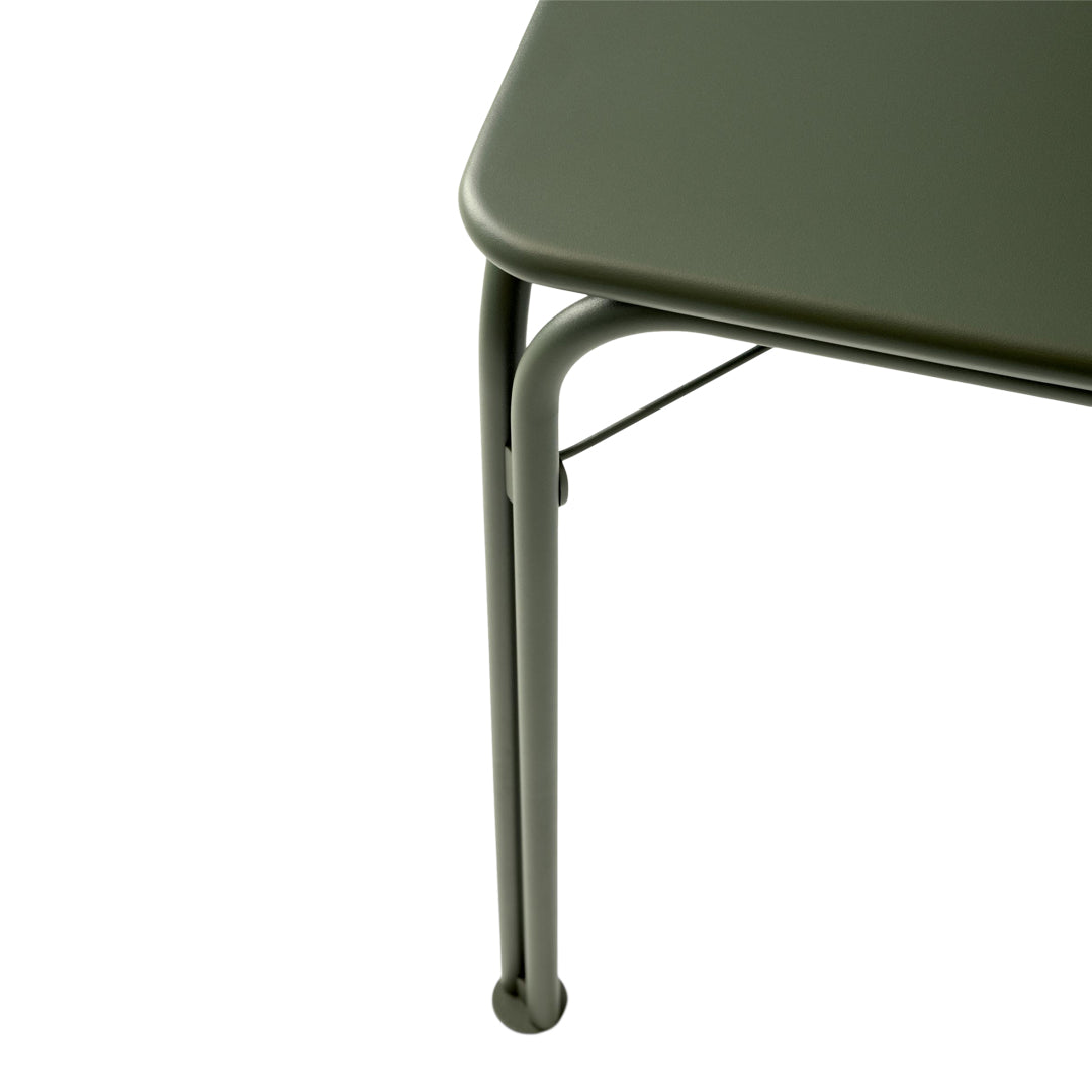Olive green table with a smooth surface and sleek, curved metal legs. Modern minimalist design.