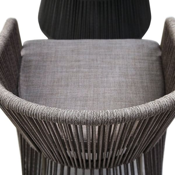 Gray woven chair with a sleek design, featuring vertical stripe patterns and a textured seat cushion.