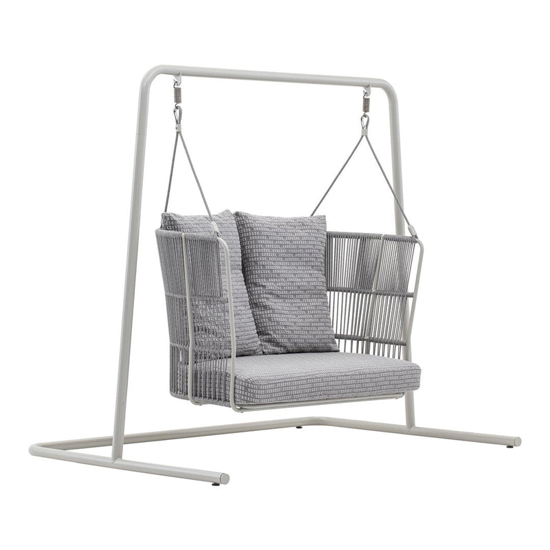 Gray patterned cushions on a white metal swing chair with a minimalistic design. Perfect for outdoor relaxation.