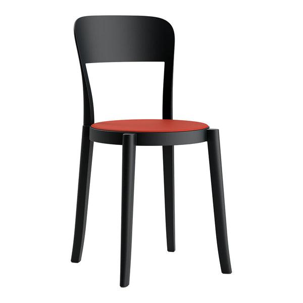 Black chair with a sleek design and vibrant red seat, perfect for modern interiors.