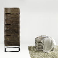 "Wooden tall dresser with a wavy design in rich brown, alongside folded blankets in neutral tones."