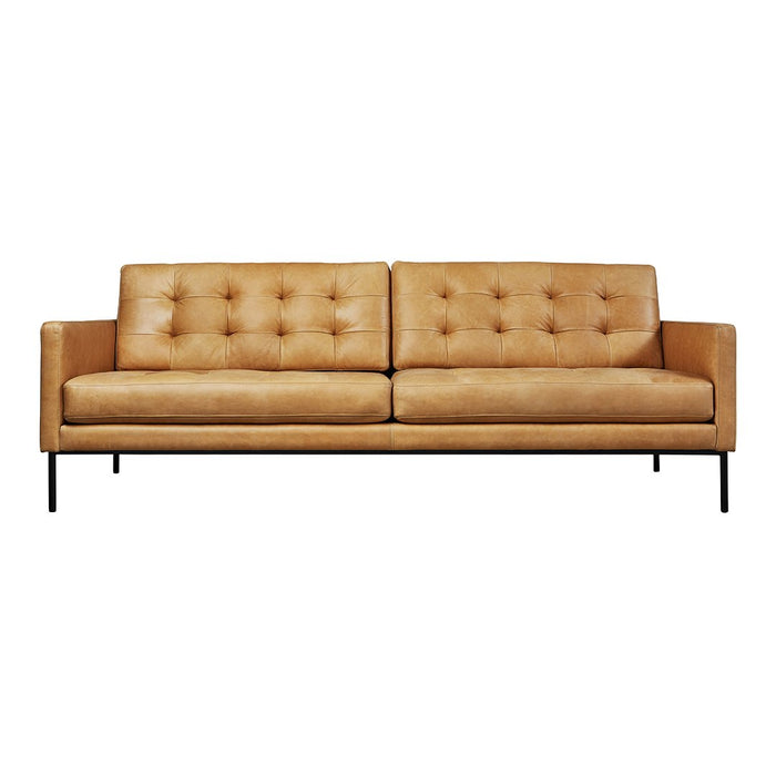 Tan leather sofa with tufted cushions and black metal legs, showcasing a modern, minimalist design.