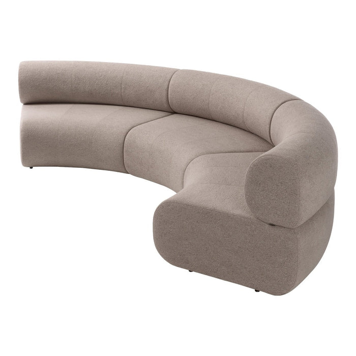 Curved, beige sofa in a modern design with smooth, upholstered surface and minimalistic lines. Perfect for contemporary decor.