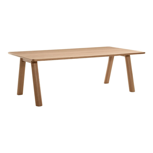 Light oak dining table with a smooth finish and minimalistic design, showcasing natural wood grain patterns.