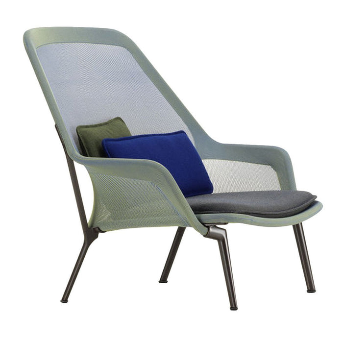 Light green mesh chair with gray seat cushion and blue, green, and gray decorative pillows. Modern, airy design.
