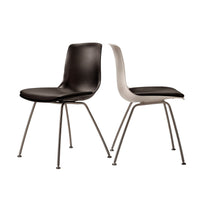 Black and white modern dining chairs with sleek curves and metal legs, ideal for contemporary aesthetics.