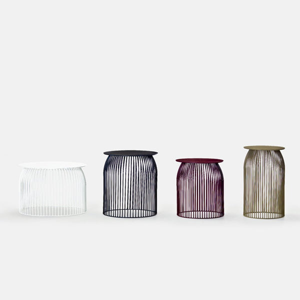 "Set of four wire vases in white, navy, burgundy, and olive green with sleek vertical line patterns."