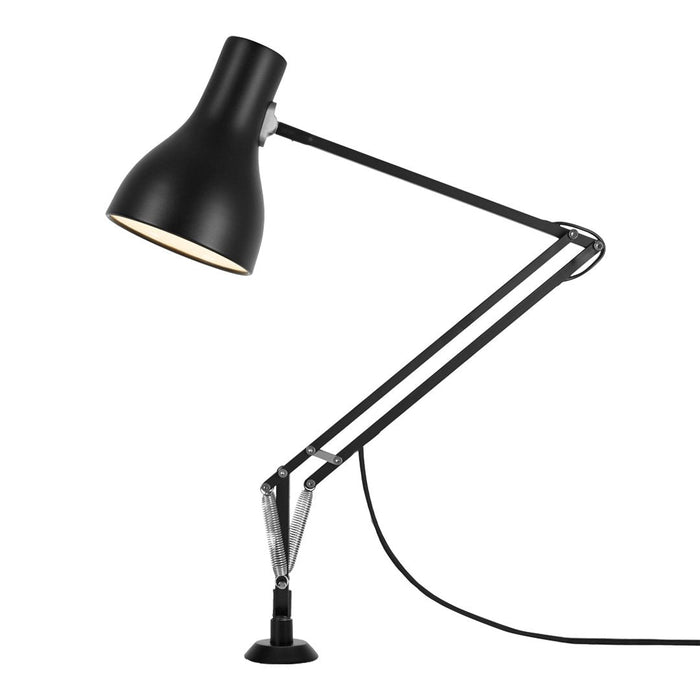 Black adjustable desk lamp with a sleek, modern design and gold accents.