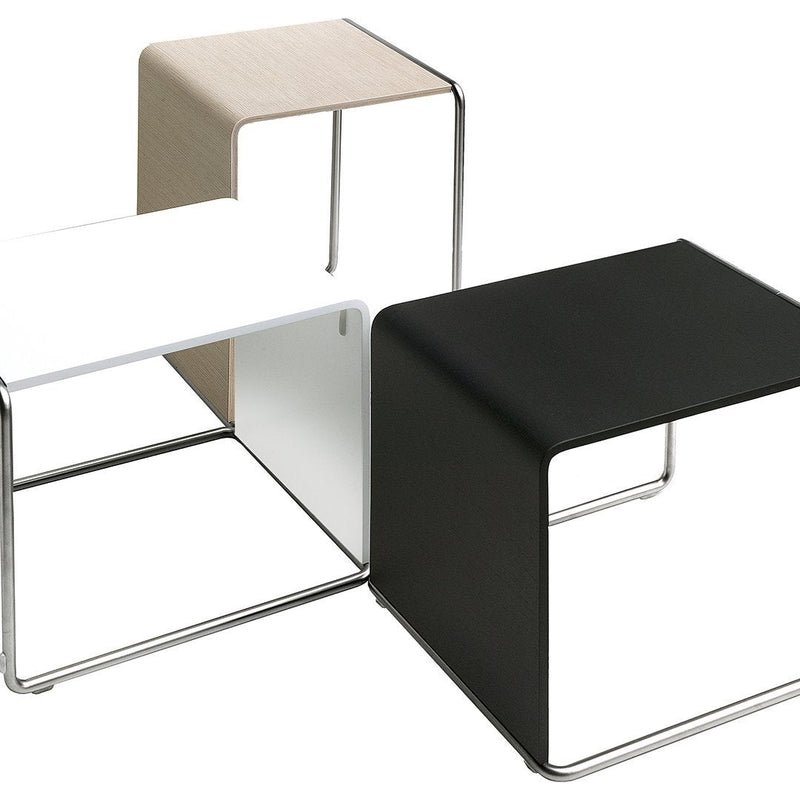 Three contemporary side tables in black, white, and beige finishes with sleek, modern lines and minimalist design.